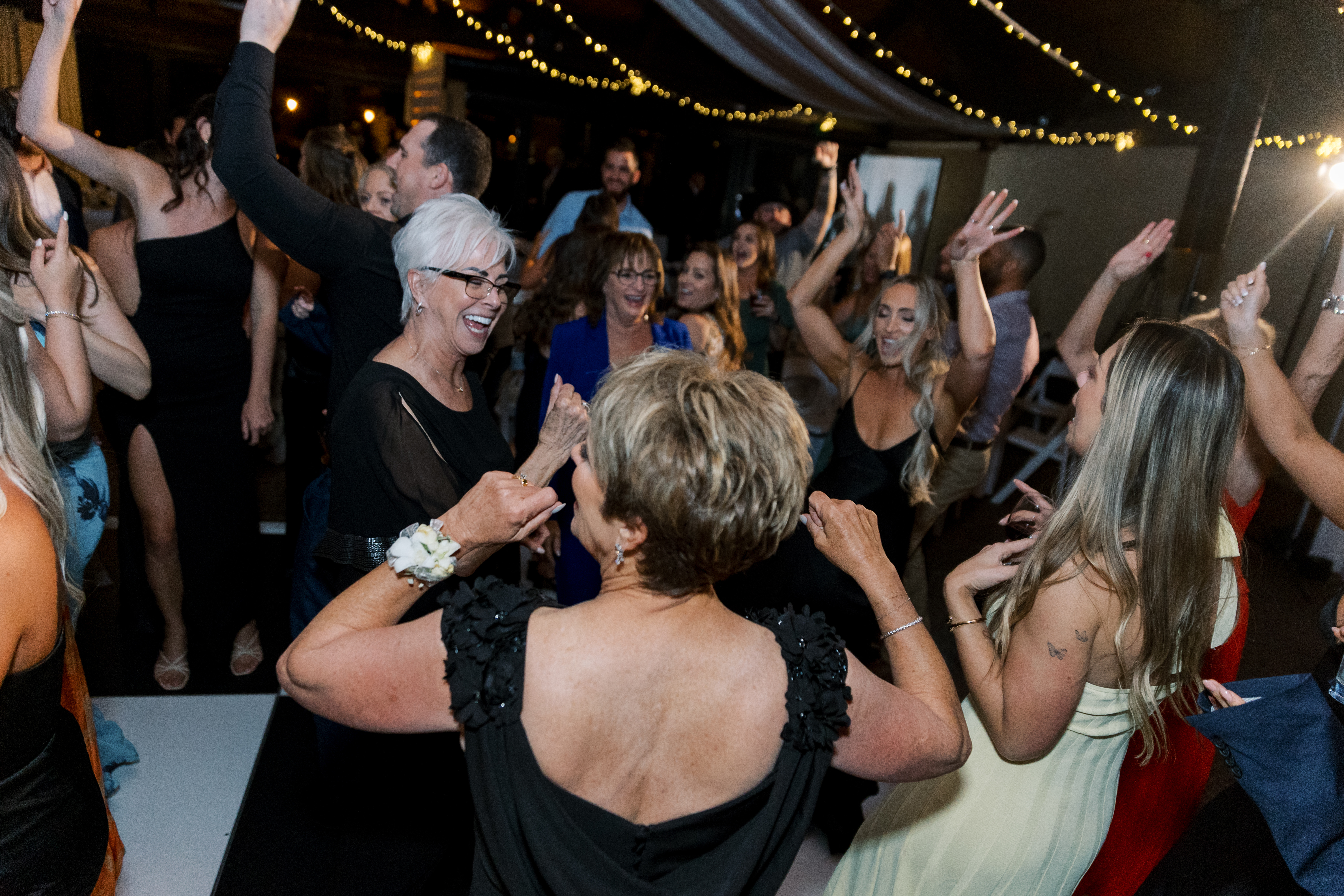Bride breakdancing as guests cheer