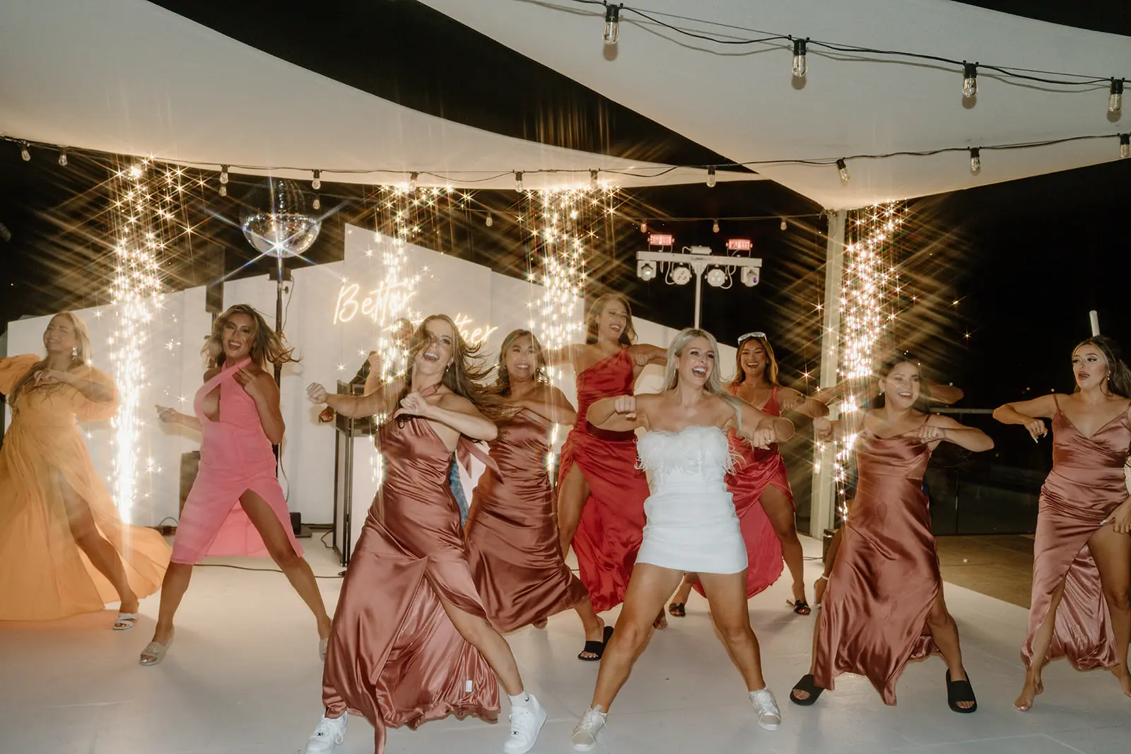 Bridesmaids dance line with sparks