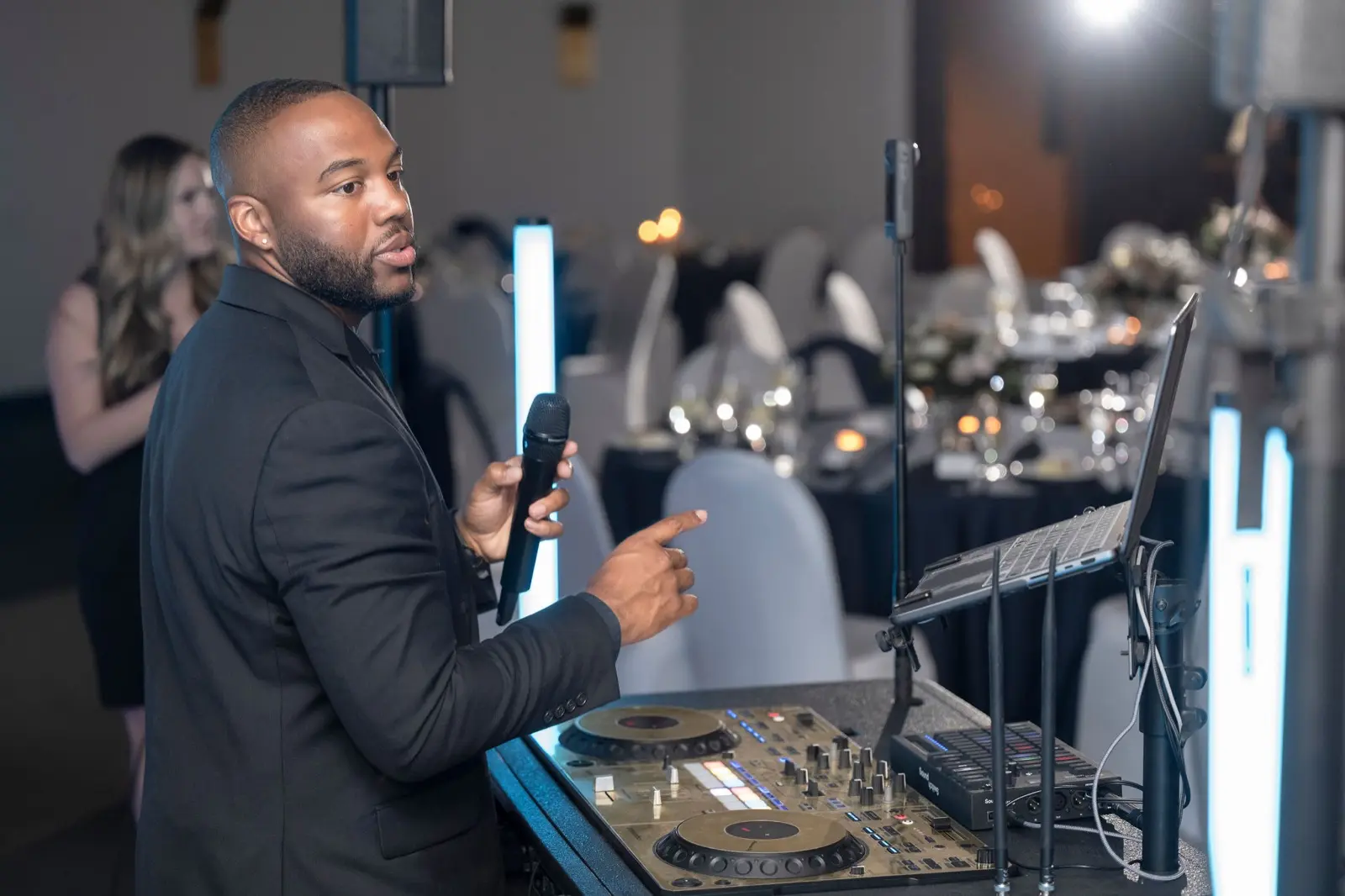 DJ Take2 on the mic at an event