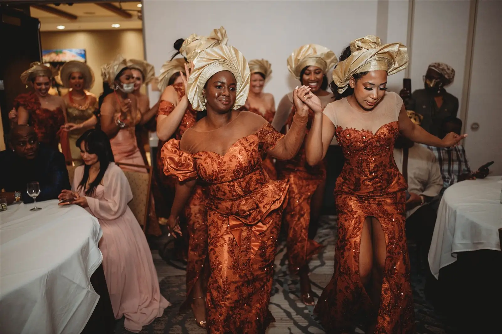 Nigerian wedding party dancing in gele