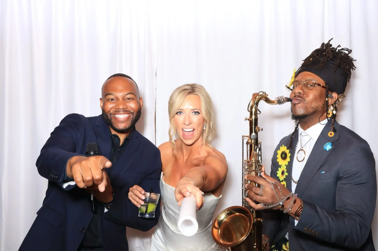 Bride in the photo booth with DJ and sax player