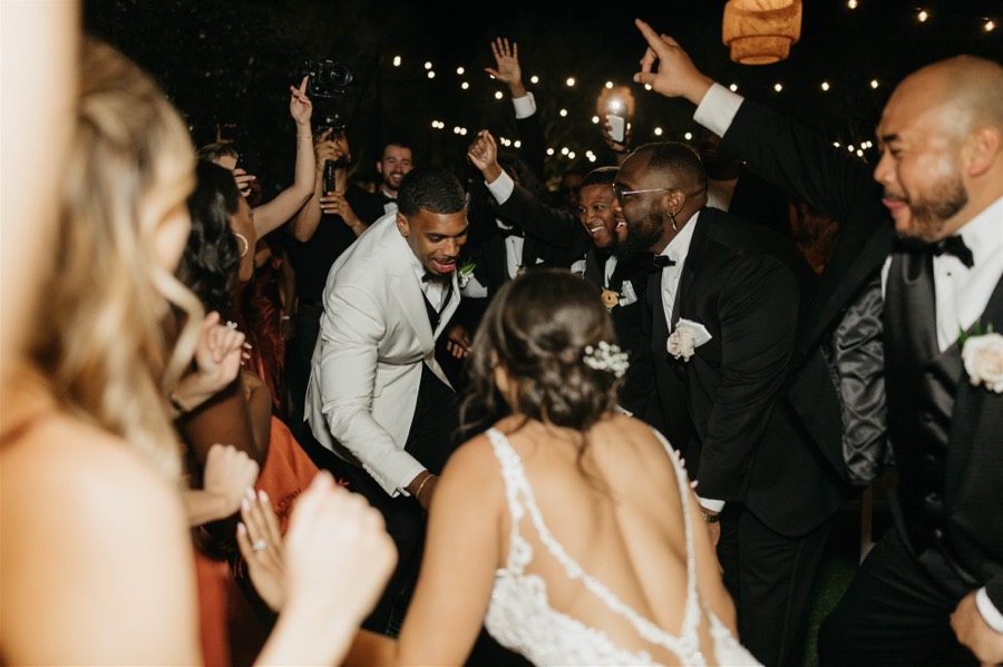 Outdoor wedding dance floor under string lights at Andaz Scottsdale Resort and Bungalows with DJ Take2